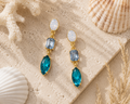 Bluewater earrings styled in a coastal flat lay