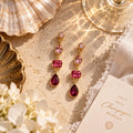 The Rosé Tide Earrings pink and berry gemstone drop earrings flat lay