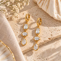 Gold crystal drop earrings flat lay