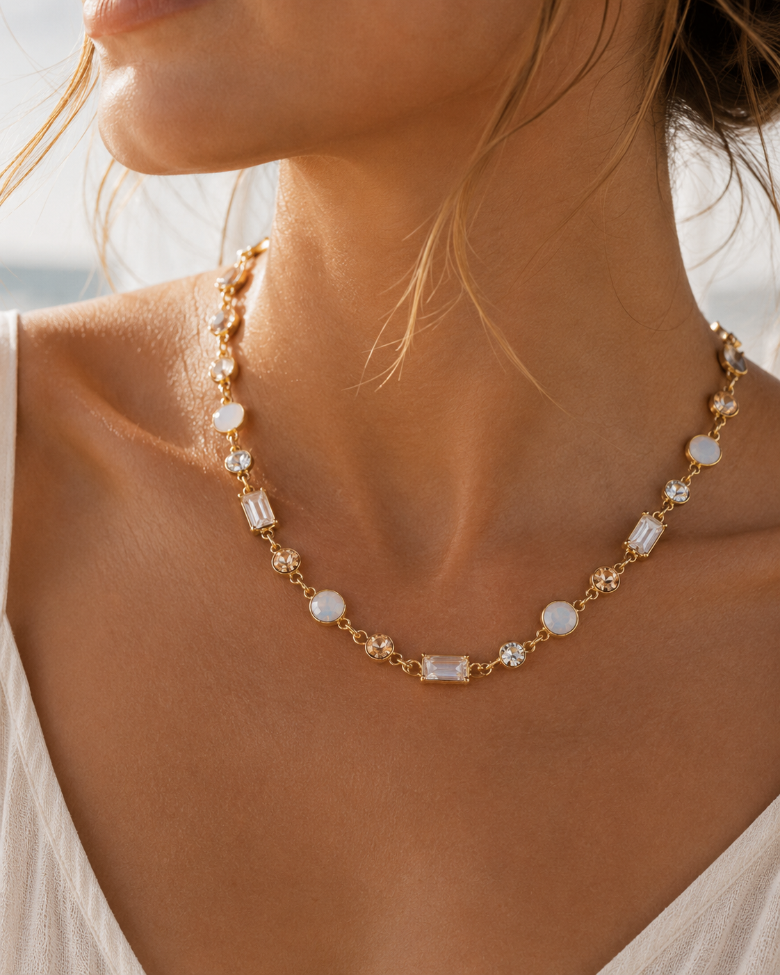 The Sea Mist Necklace worn in a warm coastal setting