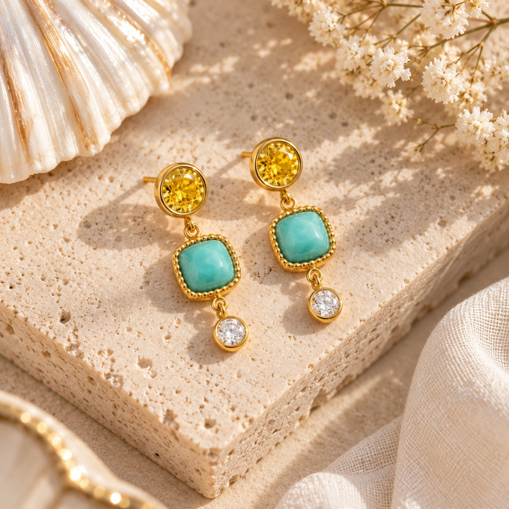Turquoise and gold drop earrings flat lay