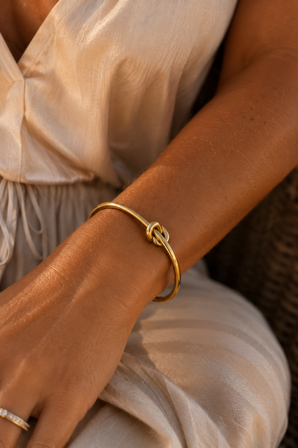 The Tybee Knot Cuff worn in warm coastal light
